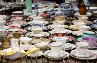 decorated coffee mugs made of fine china porcelain, also called collectors' cups, for sale at a flea market, selected focus, narrow depth of field